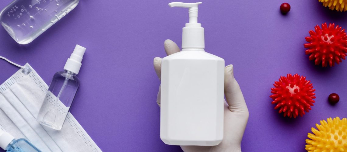 top-view-hand-holding-liquid-soap-dispenser-with-viruses (1)